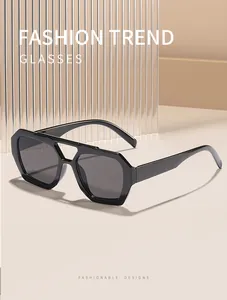 Detail view of retro double-bridge irregular oversized sunglasses with dark lenses.