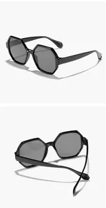 Close-up shots of black polygonal sunglasses showing retro oversized frames and grey lenses