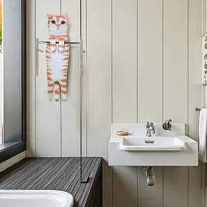 Realistic orange tabby cat hanging hand towel displayed in a modern minimalist bathroom