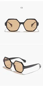 Multiple views of hexagonal black frame sunglasses with amber lenses