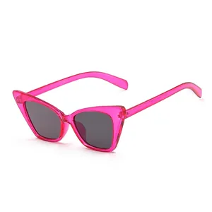 Fashionable pink cat-eye sunglasses with dark grey lenses shown on white background