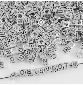 Detailed view of 7mm silver square alphabet beads for DIY jewelry making and craft projects