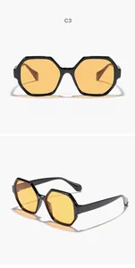 Detailed view of hexagonal sunglasses with black frames and yellow lenses