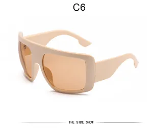Side view detail of retro oversized flat top shield sunglasses with beige frame and amber lenses