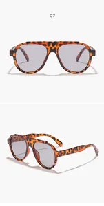 Detail view of tortoiseshell aviator sunglasses with large grey lenses and frame