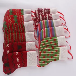 Macro view of mini knitted Christmas stockings featuring various festive patterns and colors