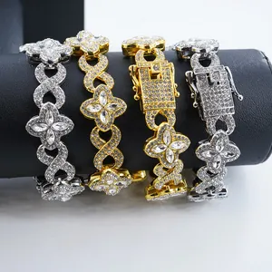 Detail shot of iced-out four-leaf clover and figure-8 link bracelets in gold and silver