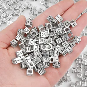 Silver 7x7mm square alphabet alloy beads for DIY jewelry making shown held in hand