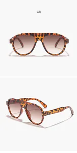 Close-up detail views of oversized tortoise shell sunglasses with gradient brown lenses
