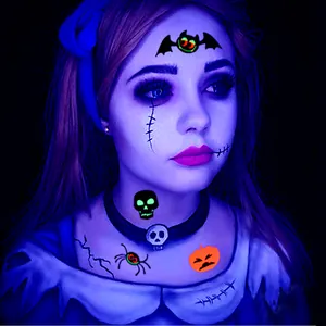 Detailed view of luminous Halloween temporary tattoos featuring bat and skull designs on skin