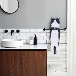 Realistic black and white cat-shaped hanging hand towel in a modern bathroom setup