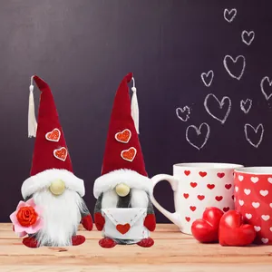 Pair of cute Mother's Day gnomes holding rose and heart envelope on a wooden table decoration
