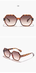Detail of retro tortoiseshell polygonal sunglasses featuring brown gradient lenses
