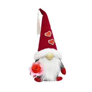 Detail of a festive gnome doll holding a rose with sequin heart accents on hat.