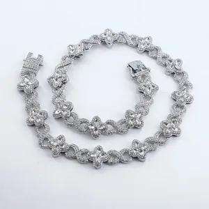 Detailed view of luxury silver iced-out four-leaf clover and infinity link Cuban chain