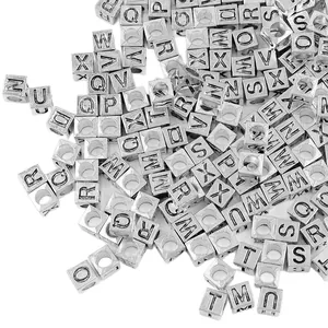7x7mm square silver alloy alphabet beads for DIY jewelry making scattered on white