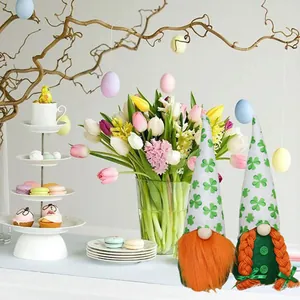 Detail view of two St. Patrick's Day gnomes with green clover pattern hats in a festive setting.