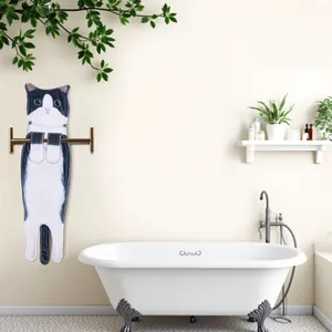 Realistic black and white cat shaped hand towel hanging on a modern bathroom towel bar.