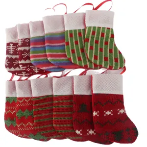 Set of mini knitted Christmas stockings with various festive patterns and hanging loops.