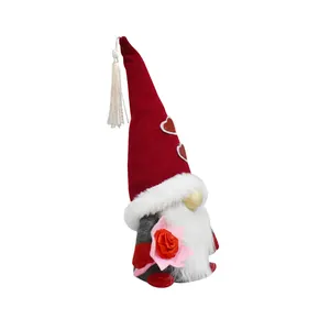 Detailed side view of Mother's Day gnome holding a pink rose decoration