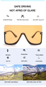 Detailed feature view of oversized shield driving sunglasses with amber tinted lenses