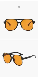 Detail of aviator sunglasses with black double bridge frame and orange lenses