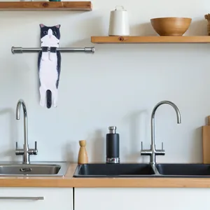 Realistic tuxedo cat hanging hand towel displayed in a modern kitchen setting