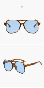 Detailed view of oversized tortoise-shell pilot sunglasses with light blue lenses.