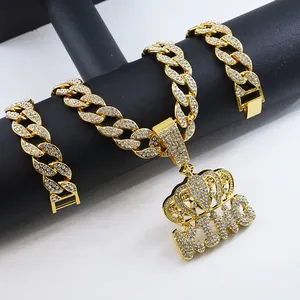 Close-up of iced out KING crown pendant with crystal cuban link chain necklace