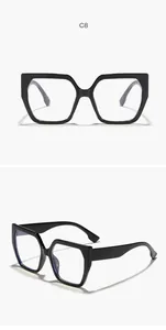 Close-up of black oversized geometric cat-eye eyeglass frames with clear lenses