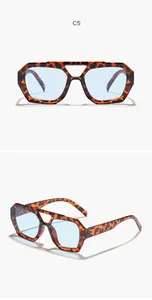 Detailed view of irregular leopard print sunglasses with blue lenses and double bridge