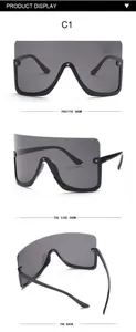 Three-angle views of oversized shield sunglasses with star studs and grey lenses