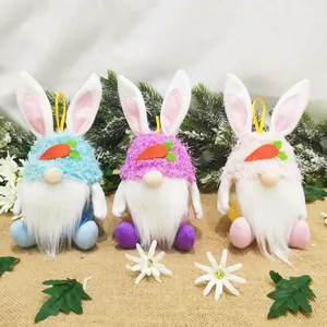 Three cute plush Easter gnomes with bunny ears and carrot accents on a burlap surface.
