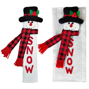 Close-up detail showing snowman refrigerator door handle covers with SNOW embroidery text