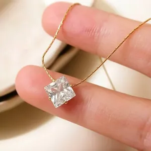 Close-up of a square clear zircon pendant on a delicate gold titanium steel chain.