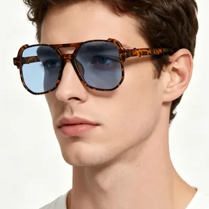 Oversized tortoiseshell pilot sunglasses with blue lenses on male model. Retro punk style.