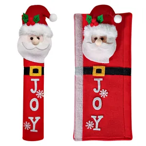 Close-up detail of Santa Claus refrigerator handle covers with JOY embroidery and snowflakes