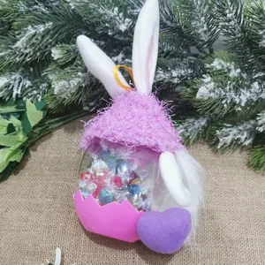 Close-up of a creative rabbit-shaped candy jar with pink and purple knitted decorations