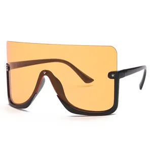 Oversized orange visor sunglasses with black frame and star stud details