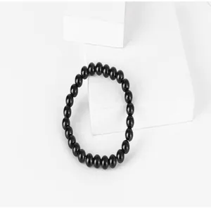 Macro detail of a minimalist handmade black titanium steel beaded bracelet for men