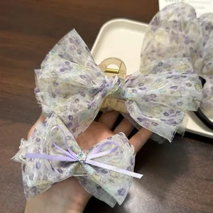 Detaillierte Nahaufnahme der eleganten Haarklammer aus lila Organza mit Blumenmuster