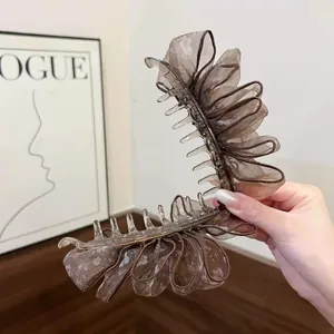 Detail of large French floral banana clip with double-layered ruffled organza mesh.