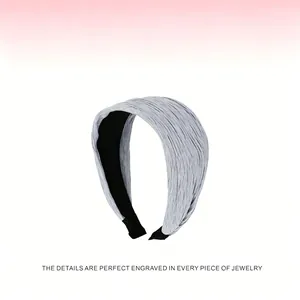 Detail view of light blue pleated wide headband with elegant texture