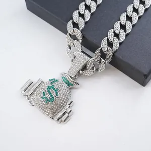 Gros plan d'un pendentif sac d'argent serti de strass sur une chaîne cubaine argentée.