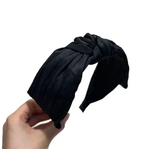 Elegant solid black pleated knotted headband with vintage style and high skull top effect