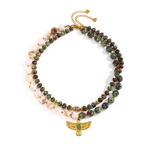 Detail view of vintage stainless steel necklace with Ruby in Zoisite beads and eagle pendant.