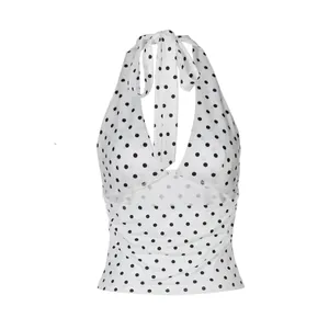 Close-up view of a stylish white polka dot halter neck top featuring a backless tie-up design