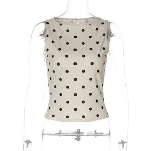 Gedetailleerd overzicht van een mouwloze damestop in beige met zwarte polkadots