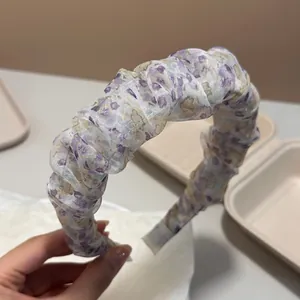 Close-up of purple floral ruffled headband with bubble cloud texture and sheer fabric