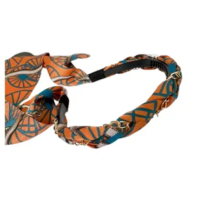 Cerchietto vintage con catena, tessuto in raso arancione e nastro decorativo lungo.